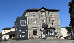 The stone frontage of Padarn Hotel in Llanberis on a sunny day